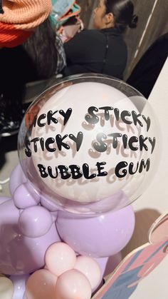 there is a bubble gum ball with writing on it that says sticky sticky sticky sticky