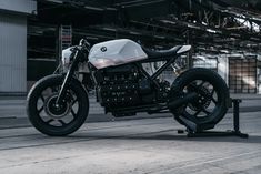 a white motorcycle parked in front of a building