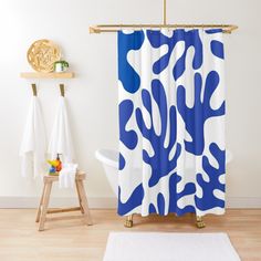 a blue and white shower curtain hanging on a wall next to a bathtub in a bathroom