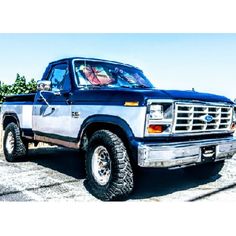 a blue pick up truck parked in a parking lot