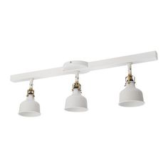 three light track lighting with white shades and gold trims on an overhead track fixture