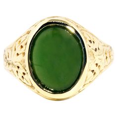 Forged in 14 carat yellow gold, this gorgeous vintage ring, circa 1980s, features an opulent deep green Nephrite jade cabochon set on patterned domed shoulders. This lovely adornment has been named The Logan Ring. She is a graceful everyday ring with wonderfully dark green hues and is fit for any occasion. The Logan Ring Gem Details The oval deep green Nephrite jade cabochon measures approximately 13 x 10 millimetres. Ring Size T 1/2 (Australia and UK sizing) or 10 (US and Canada) The Logan Ring Collectible Green 14k Stamped Jewelry, Heirloom Style Green Emerald Ring With Polished Finish, Heirloom Style Polished Emerald Ring, Green Signet Ring With Oval Cabochon Gemstone, Green Oval Cabochon Gemstone Signet Ring, Green Oval Cabochon Signet Ring, Heirloom Jade Jewelry In Green, Heirloom Green Jade Jewelry, Antique Green Jewelry With Polished Finish