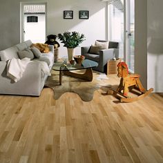 a living room filled with furniture and wooden floors