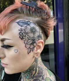 a woman with tattoos on her face and neck