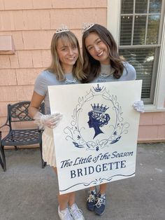 two girls are holding a sign that says the little queen of the snowbridgeette