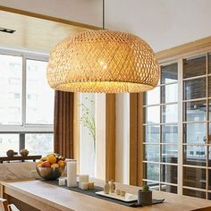 a dining room table with chairs and a light fixture hanging from it's ceiling