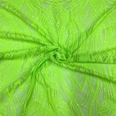 the fabric is bright green and has small white dots on it, as well as an intricate