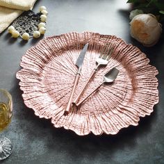 a pink plate with two forks on it