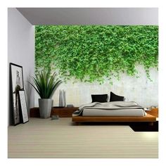 a bedroom with white walls and green plants on the wall