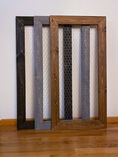 three wooden frames with different patterns on them in front of a white wall and wood floor