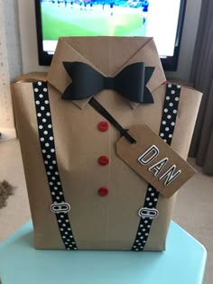 a paper bag that has a tie and bowtie on it