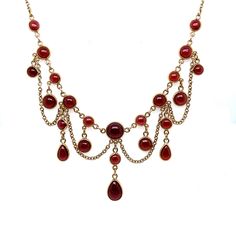 It's going to be hard to let this piece go!! It really just has everything an Antique lover can possible want in a piece! And it is GORGEOUS! Crafted in 14K Yellow Gold, the necklace features a wonderful chandelier of open back garnets! And these garnets are amazing - beautifully cut Cabochon Rounds and Pears totaling approximately 15.00ct. I seriously might end up keeping this one for myself!  Other Important Details:  The necklace is 18 inches long.  The necklace is stamped 14K, and has been tested to be 14K Yellow Gold.  The piece weighs 15.1 grams total.   The total carat weight for this necklace is approximately 15CT.  The garnet color is perfect.  This piece is in very good condition, with no major defects, and a secure clasp.  Sizing and Engraving available for an additional charge. Yellow Gold Oval Garnet Necklace, Yellow Gold Garnet Necklaces With Oval Shape, Luxury Red Cabochon Necklaces, Elegant Yellow Gold Garnet Necklace, Luxury Red Cabochon Necklace, Autumn Court, Vintage Red Garnet Necklace, Victorian Garnet Necklace, Cabin Door