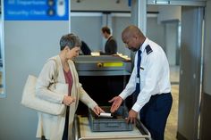 a man and woman at an airport check in counter