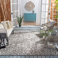 a living room filled with furniture and plants