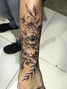 a woman's arm with flowers on it