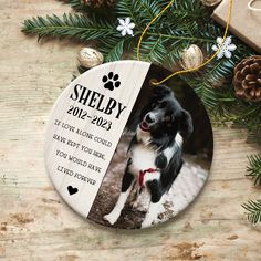 an ornament with a dog's photo on it next to christmas decorations