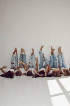 a group of people laying on the ground with their hands in the air