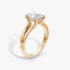 a yellow gold engagement ring with a princess cut diamond