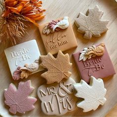 some cookies are sitting on a plate with autumn leaves and words written on the top