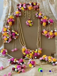 an assortment of flowers and pearls on display