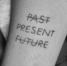 a black and white photo of someone's arm with the words past present future on it