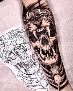 a man's arm with tattoos on it and an image of a tiger in the background