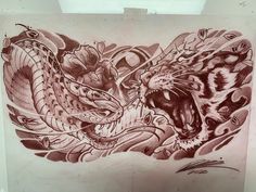 a drawing of a tiger and a dragon on a piece of paper that is taped to the wall