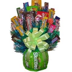 a green vase filled with assorted candy