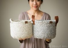 a woman holding two baskets in her hands