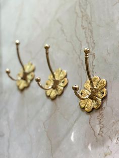 Enhance your home with this handcrafted Moroccan brass flower hook, designed with elegance and tradition. Made from 100% solid brass, this exquisite hook is individually engraved by skilled artisans, showcasing the beauty of Moroccan craftsmanship. Ideal for bathrooms, kitchens, or entryways, these hooks provide an elegant yet functional touch to any space. ✨ Product Features: *Material: 100% solid brass (not plated) *Size: 4.33 inches (11 cm) height × 3.14 inches (8 cm) width *Design: Inspired Patina Design, Brass Wall Hook, Bathroom Towel Hooks, Kitchen Wall Hangings, Moroccan Wall, Brass Hooks, Decorative Wall Hooks, Natural Aging, Home Goals