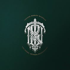 an ornate monogrammed logo on a dark green background