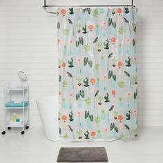 a bathroom with a cactus shower curtain and rug