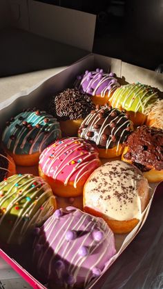 a box filled with lots of different flavored donuts