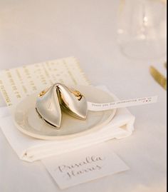 a white plate topped with two gold rings