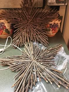 a star made out of sticks sitting on top of a counter next to other items