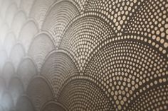 a close up view of an intricate pattern on a wallpapered surface with circles