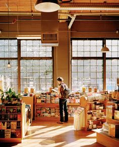 a person standing in a room with lots of books