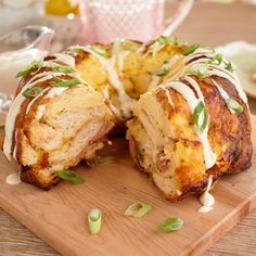 a meatloaf covered in sauce and garnished with green onions on a cutting board