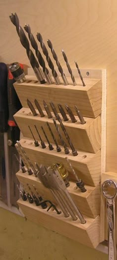 there are many tools in the holder on the shelf with it's screwdrivers