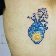 a heart tattoo on the side of a woman's stomach with flowers growing out of it