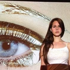 a woman standing in front of an eye