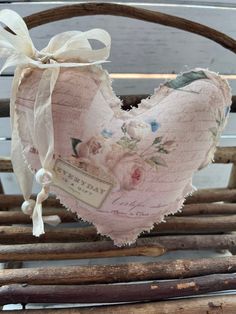 a heart shaped pillow sitting on top of a wooden chair