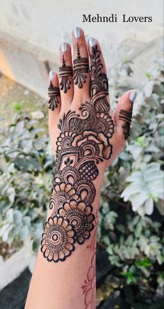 a woman's hand with henna tattoos on it and the words mehndi lovers