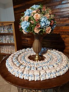 a vase filled with flowers sitting on top of a table covered in baby's breath diapers