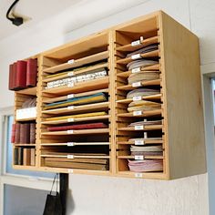 a wooden shelf filled with lots of files