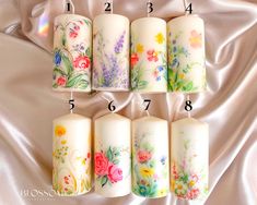 six candles with flowers painted on them