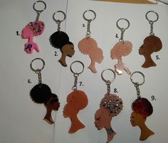 a bunch of key chains with different types of hair styles on them and numbers in the middle