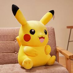 a stuffed pikachu sitting on top of a couch