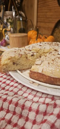 a cake on a white plate sitting on a red and white checkered table cloth