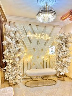 a room decorated with white flowers and lights